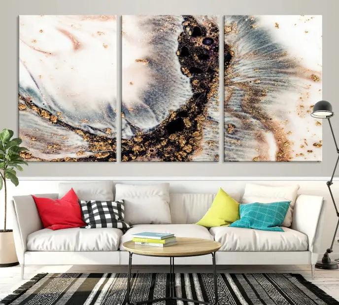 The Brown Marble Fluid Effect Wall Art Abstract Canvas Wall Art Print, with its mesmerizing black, white, and gold swirls, brings an exquisite touch to the space. This museum-quality canvas is elegantly displayed in a modern living room setting.