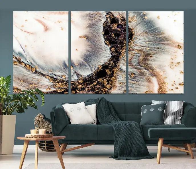 The Brown Marble Fluid Effect Wall Art Abstract Canvas Wall Art Print, with its mesmerizing black, white, and gold swirls, brings an exquisite touch to the space. This museum-quality canvas is elegantly displayed in a modern living room setting.