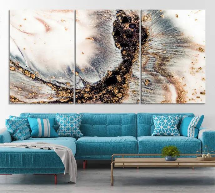 The Brown Marble Fluid Effect Wall Art Abstract Canvas Wall Art Print, with its mesmerizing black, white, and gold swirls, brings an exquisite touch to the space. This museum-quality canvas is elegantly displayed in a modern living room setting.