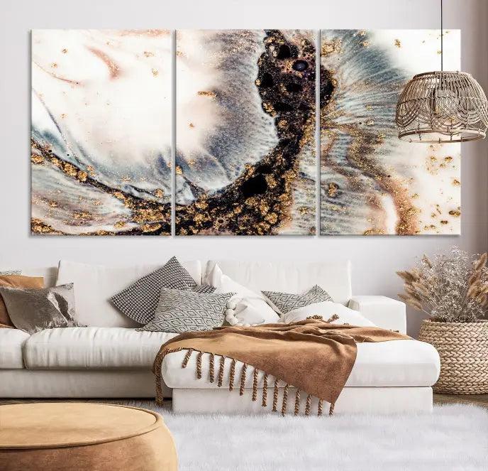 The Brown Marble Fluid Effect Wall Art Abstract Canvas Wall Art Print, with its mesmerizing black, white, and gold swirls, brings an exquisite touch to the space. This museum-quality canvas is elegantly displayed in a modern living room setting.