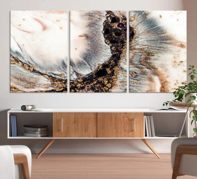 The Brown Marble Fluid Effect Wall Art Abstract Canvas Wall Art Print, with its mesmerizing black, white, and gold swirls, brings an exquisite touch to the space. This museum-quality canvas is elegantly displayed in a modern living room setting.