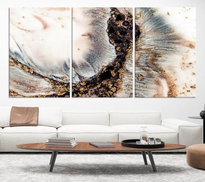 The Brown Marble Fluid Effect Wall Art Abstract Canvas Wall Art Print, with its mesmerizing black, white, and gold swirls, brings an exquisite touch to the space. This museum-quality canvas is elegantly displayed in a modern living room setting.