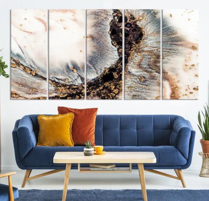 The Brown Marble Fluid Effect Wall Art Abstract Canvas Wall Art Print, with its mesmerizing black, white, and gold swirls, brings an exquisite touch to the space. This museum-quality canvas is elegantly displayed in a modern living room setting.