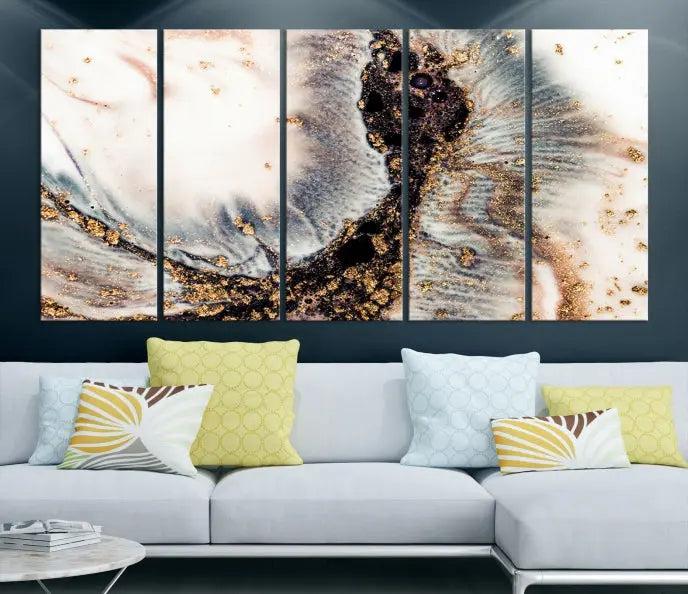 The Brown Marble Fluid Effect Wall Art Abstract Canvas Wall Art Print, with its mesmerizing black, white, and gold swirls, brings an exquisite touch to the space. This museum-quality canvas is elegantly displayed in a modern living room setting.