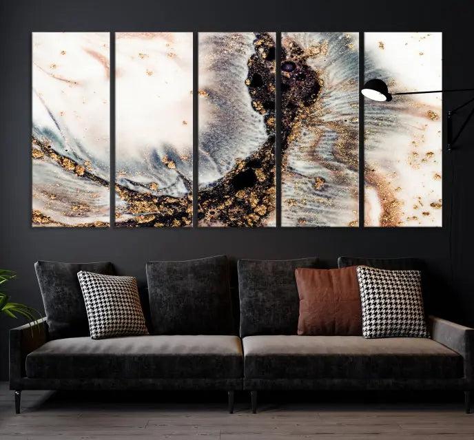 The Brown Marble Fluid Effect Wall Art Abstract Canvas Wall Art Print, with its mesmerizing black, white, and gold swirls, brings an exquisite touch to the space. This museum-quality canvas is elegantly displayed in a modern living room setting.