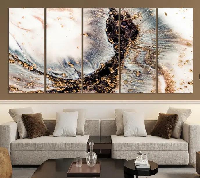 The Brown Marble Fluid Effect Wall Art Abstract Canvas Wall Art Print, with its mesmerizing black, white, and gold swirls, brings an exquisite touch to the space. This museum-quality canvas is elegantly displayed in a modern living room setting.