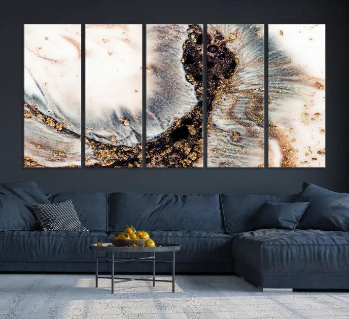 The Brown Marble Fluid Effect Wall Art Abstract Canvas Wall Art Print, with its mesmerizing black, white, and gold swirls, brings an exquisite touch to the space. This museum-quality canvas is elegantly displayed in a modern living room setting.