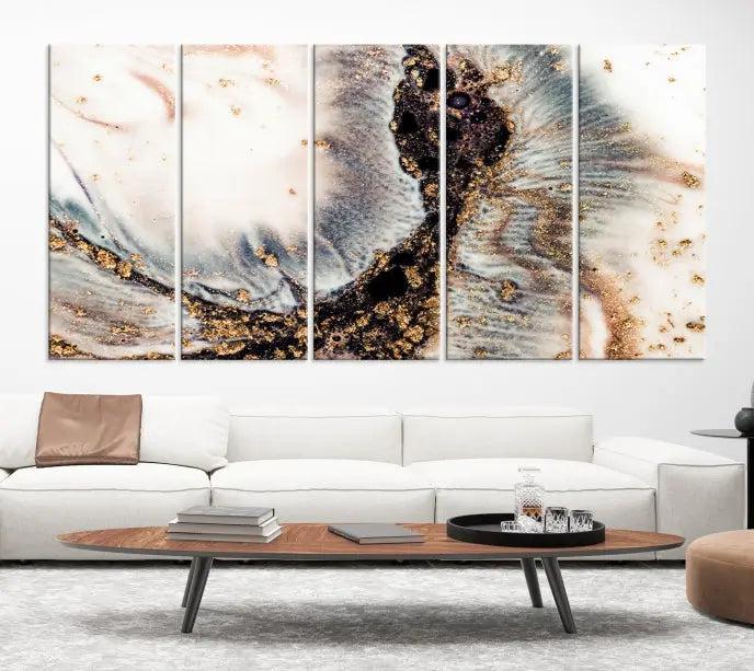 The Brown Marble Fluid Effect Wall Art Abstract Canvas Wall Art Print, with its mesmerizing black, white, and gold swirls, brings an exquisite touch to the space. This museum-quality canvas is elegantly displayed in a modern living room setting.