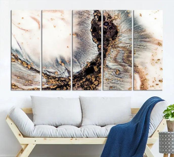 The Brown Marble Fluid Effect Wall Art Abstract Canvas Wall Art Print, with its mesmerizing black, white, and gold swirls, brings an exquisite touch to the space. This museum-quality canvas is elegantly displayed in a modern living room setting.