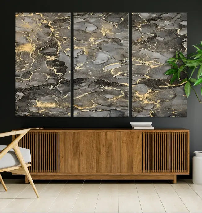 The Brown Yellow Marble Fluid Effect Abstract Canvas Wall Art Print, expertly wrapped on museum-quality canvas, enhances the dark wall with intricate gold and gray swirls.