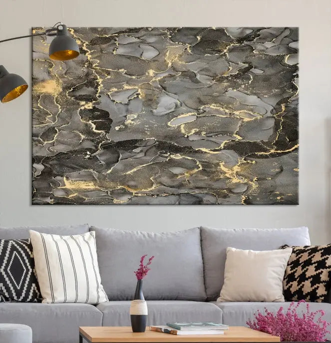 The Brown Yellow Marble Fluid Effect Abstract Canvas Wall Art Print, expertly wrapped on museum-quality canvas, enhances the dark wall with intricate gold and gray swirls.