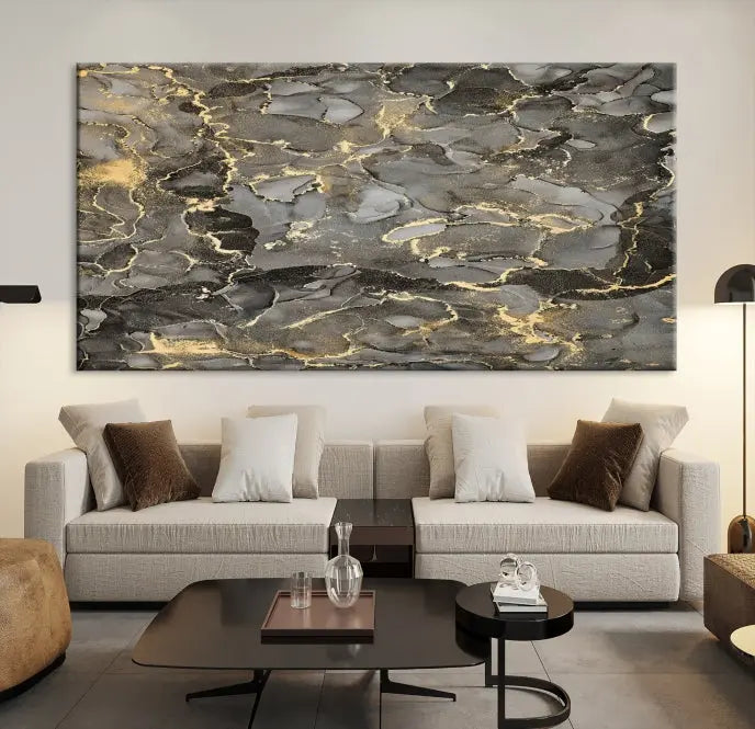 The Brown Yellow Marble Fluid Effect Abstract Canvas Wall Art Print, expertly wrapped on museum-quality canvas, enhances the dark wall with intricate gold and gray swirls.