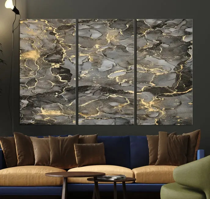 The Brown Yellow Marble Fluid Effect Abstract Canvas Wall Art Print, expertly wrapped on museum-quality canvas, enhances the dark wall with intricate gold and gray swirls.