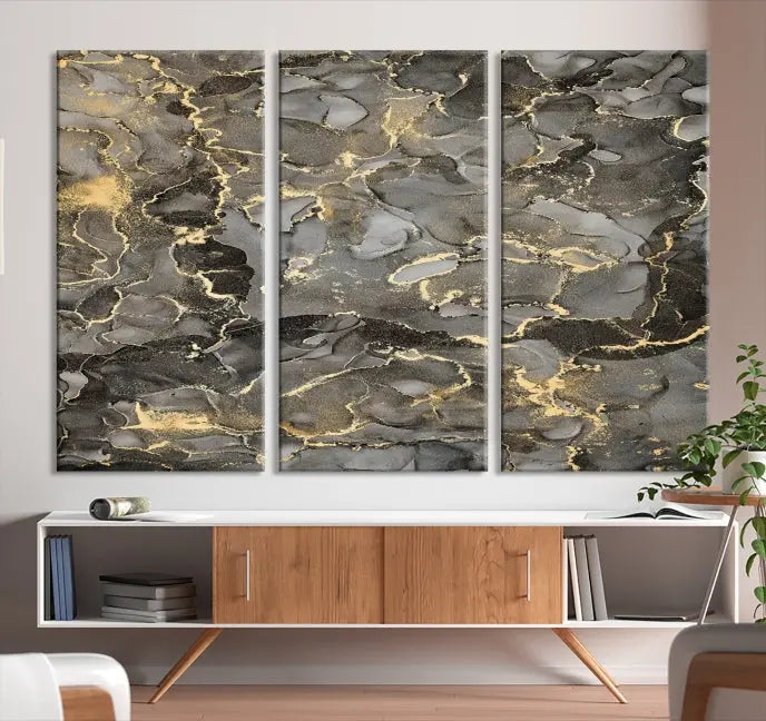 The Brown Yellow Marble Fluid Effect Abstract Canvas Wall Art Print, expertly wrapped on museum-quality canvas, enhances the dark wall with intricate gold and gray swirls.