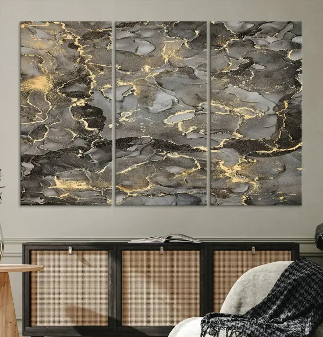 The Brown Yellow Marble Fluid Effect Abstract Canvas Wall Art Print, expertly wrapped on museum-quality canvas, enhances the dark wall with intricate gold and gray swirls.