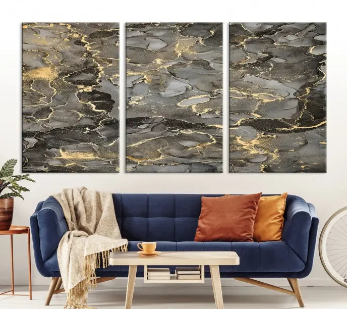 The Brown Yellow Marble Fluid Effect Abstract Canvas Wall Art Print, expertly wrapped on museum-quality canvas, enhances the dark wall with intricate gold and gray swirls.