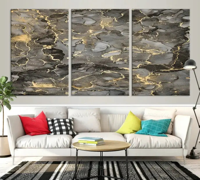 The Brown Yellow Marble Fluid Effect Abstract Canvas Wall Art Print, expertly wrapped on museum-quality canvas, enhances the dark wall with intricate gold and gray swirls.