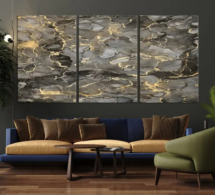 The Brown Yellow Marble Fluid Effect Abstract Canvas Wall Art Print, expertly wrapped on museum-quality canvas, enhances the dark wall with intricate gold and gray swirls.