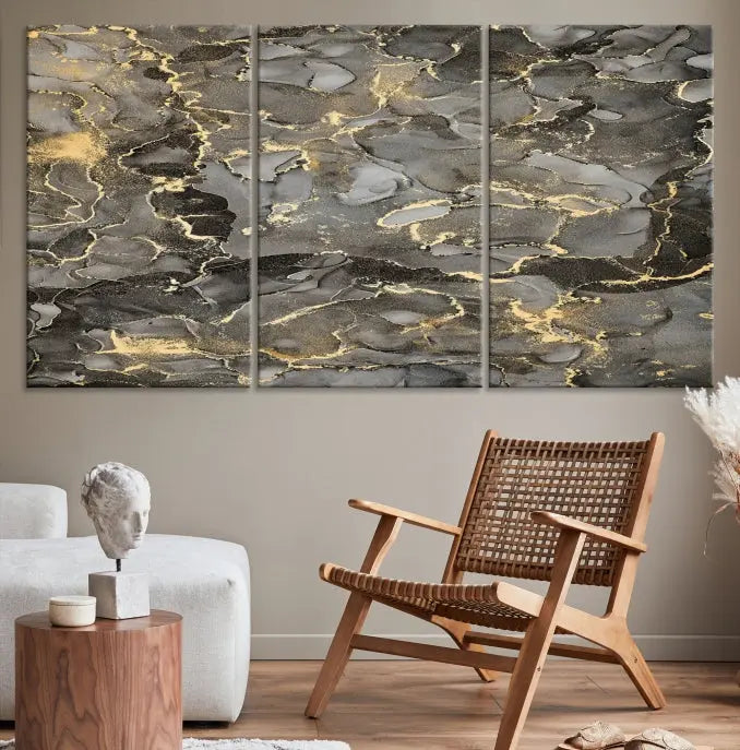 The Brown Yellow Marble Fluid Effect Abstract Canvas Wall Art Print, expertly wrapped on museum-quality canvas, enhances the dark wall with intricate gold and gray swirls.