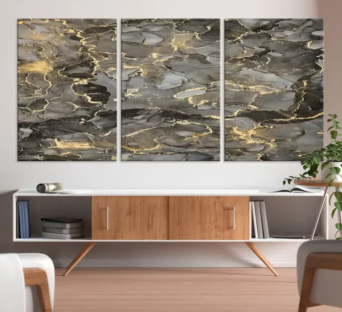 The Brown Yellow Marble Fluid Effect Abstract Canvas Wall Art Print, expertly wrapped on museum-quality canvas, enhances the dark wall with intricate gold and gray swirls.