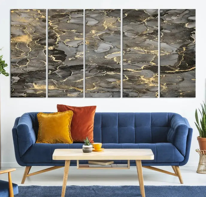 The Brown Yellow Marble Fluid Effect Abstract Canvas Wall Art Print, expertly wrapped on museum-quality canvas, enhances the dark wall with intricate gold and gray swirls.