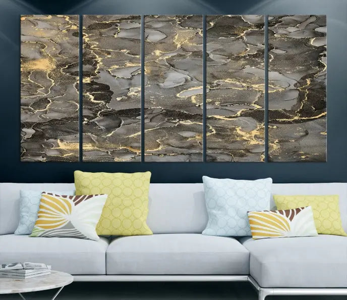 The Brown Yellow Marble Fluid Effect Abstract Canvas Wall Art Print, expertly wrapped on museum-quality canvas, enhances the dark wall with intricate gold and gray swirls.