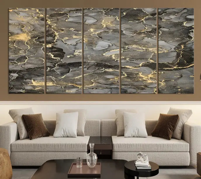 The Brown Yellow Marble Fluid Effect Abstract Canvas Wall Art Print, expertly wrapped on museum-quality canvas, enhances the dark wall with intricate gold and gray swirls.