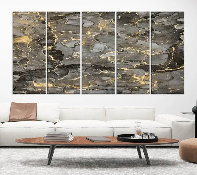 The Brown Yellow Marble Fluid Effect Abstract Canvas Wall Art Print, expertly wrapped on museum-quality canvas, enhances the dark wall with intricate gold and gray swirls.