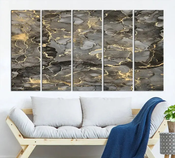 The Brown Yellow Marble Fluid Effect Abstract Canvas Wall Art Print, expertly wrapped on museum-quality canvas, enhances the dark wall with intricate gold and gray swirls.