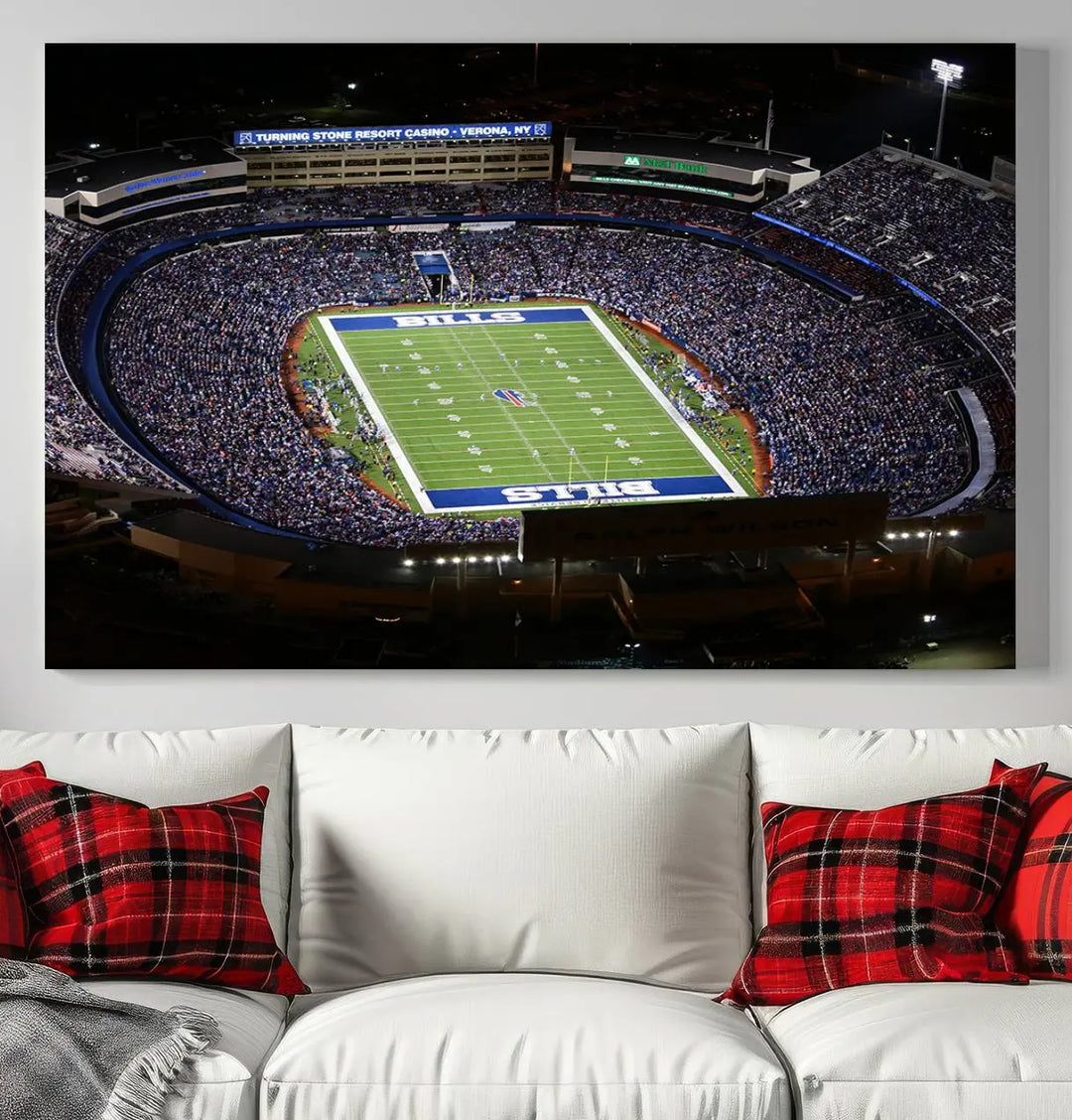 Above the couch hangs a museum-quality triptych featuring the Buffalo Bills NFL Football Team: a stunning canvas print of Highmark Stadium packed with enthusiastic spectators at night. The high-resolution printing technique captures every detail to perfection, making it ready to hang and instantly elevate any space.