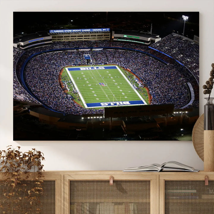 Above the couch hangs a museum-quality triptych featuring the Buffalo Bills NFL Football Team: a stunning canvas print of Highmark Stadium packed with enthusiastic spectators at night. The high-resolution printing technique captures every detail to perfection, making it ready to hang and instantly elevate any space.