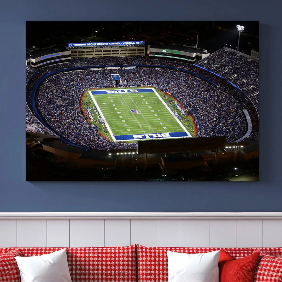 Above the couch hangs a museum-quality triptych featuring the Buffalo Bills NFL Football Team: a stunning canvas print of Highmark Stadium packed with enthusiastic spectators at night. The high-resolution printing technique captures every detail to perfection, making it ready to hang and instantly elevate any space.