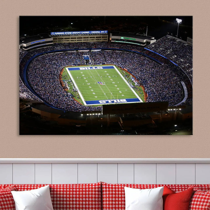 Above the couch hangs a museum-quality triptych featuring the Buffalo Bills NFL Football Team: a stunning canvas print of Highmark Stadium packed with enthusiastic spectators at night. The high-resolution printing technique captures every detail to perfection, making it ready to hang and instantly elevate any space.