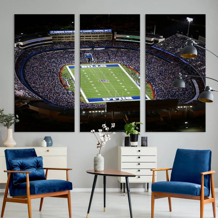 Above the couch hangs a museum-quality triptych featuring the Buffalo Bills NFL Football Team: a stunning canvas print of Highmark Stadium packed with enthusiastic spectators at night. The high-resolution printing technique captures every detail to perfection, making it ready to hang and instantly elevate any space.