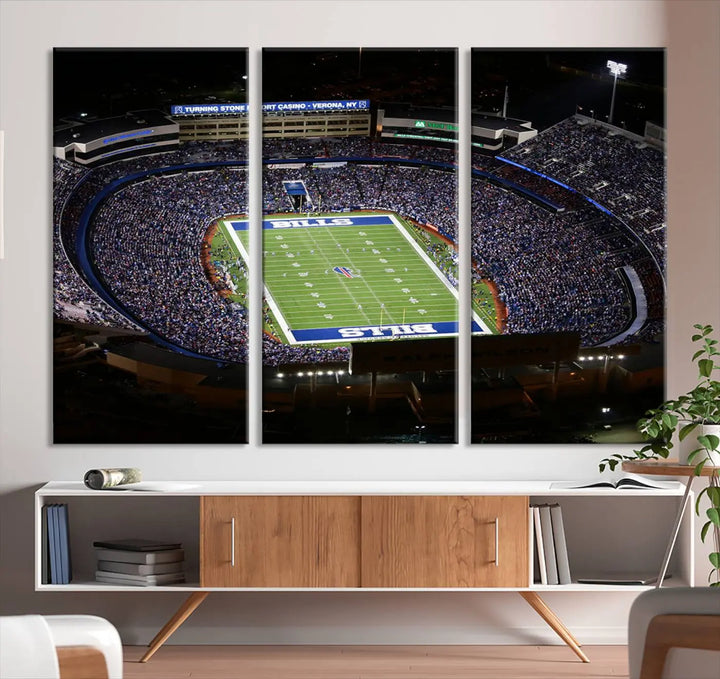 Above the couch hangs a museum-quality triptych featuring the Buffalo Bills NFL Football Team: a stunning canvas print of Highmark Stadium packed with enthusiastic spectators at night. The high-resolution printing technique captures every detail to perfection, making it ready to hang and instantly elevate any space.