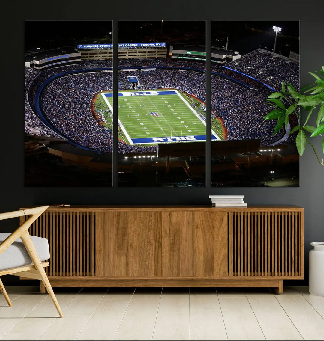 Above the couch hangs a museum-quality triptych featuring the Buffalo Bills NFL Football Team: a stunning canvas print of Highmark Stadium packed with enthusiastic spectators at night. The high-resolution printing technique captures every detail to perfection, making it ready to hang and instantly elevate any space.