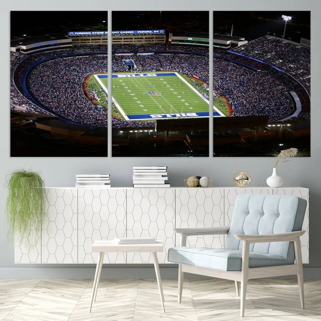 Above the couch hangs a museum-quality triptych featuring the Buffalo Bills NFL Football Team: a stunning canvas print of Highmark Stadium packed with enthusiastic spectators at night. The high-resolution printing technique captures every detail to perfection, making it ready to hang and instantly elevate any space.