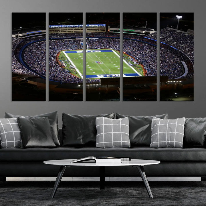 Above the couch hangs a museum-quality triptych featuring the Buffalo Bills NFL Football Team: a stunning canvas print of Highmark Stadium packed with enthusiastic spectators at night. The high-resolution printing technique captures every detail to perfection, making it ready to hang and instantly elevate any space.