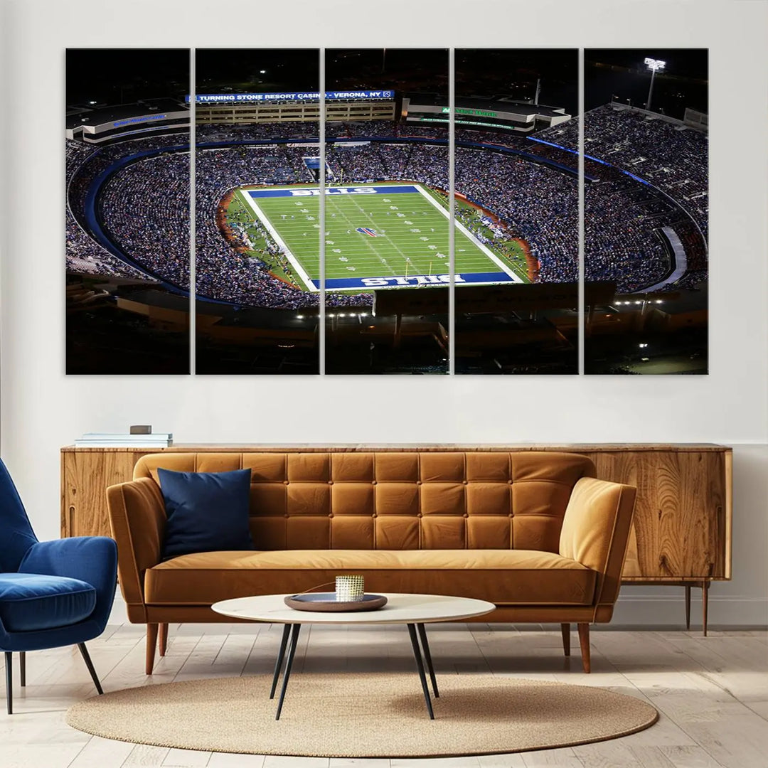 Above the couch hangs a museum-quality triptych featuring the Buffalo Bills NFL Football Team: a stunning canvas print of Highmark Stadium packed with enthusiastic spectators at night. The high-resolution printing technique captures every detail to perfection, making it ready to hang and instantly elevate any space.