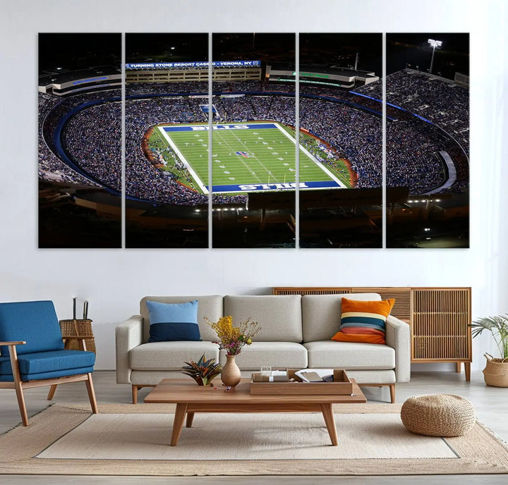 Above the couch hangs a museum-quality triptych featuring the Buffalo Bills NFL Football Team: a stunning canvas print of Highmark Stadium packed with enthusiastic spectators at night. The high-resolution printing technique captures every detail to perfection, making it ready to hang and instantly elevate any space.