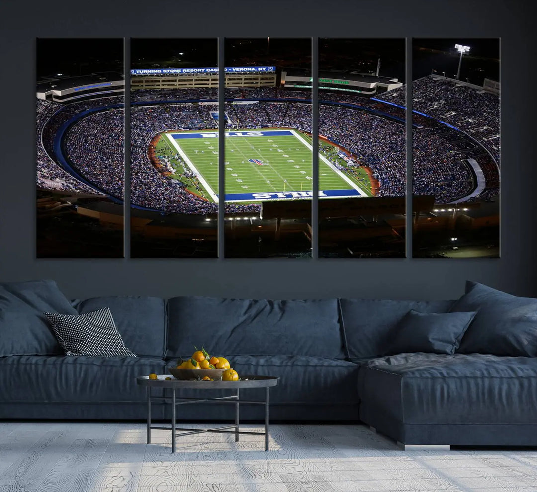 Above the couch hangs a museum-quality triptych featuring the Buffalo Bills NFL Football Team: a stunning canvas print of Highmark Stadium packed with enthusiastic spectators at night. The high-resolution printing technique captures every detail to perfection, making it ready to hang and instantly elevate any space.