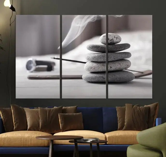 The "Burning Incense and Zen Stones Buddhism Wall Art Canvas Print" adds an artistic touch to the contemporary living room with its museum-quality depiction of stacked stones and incense smoke.