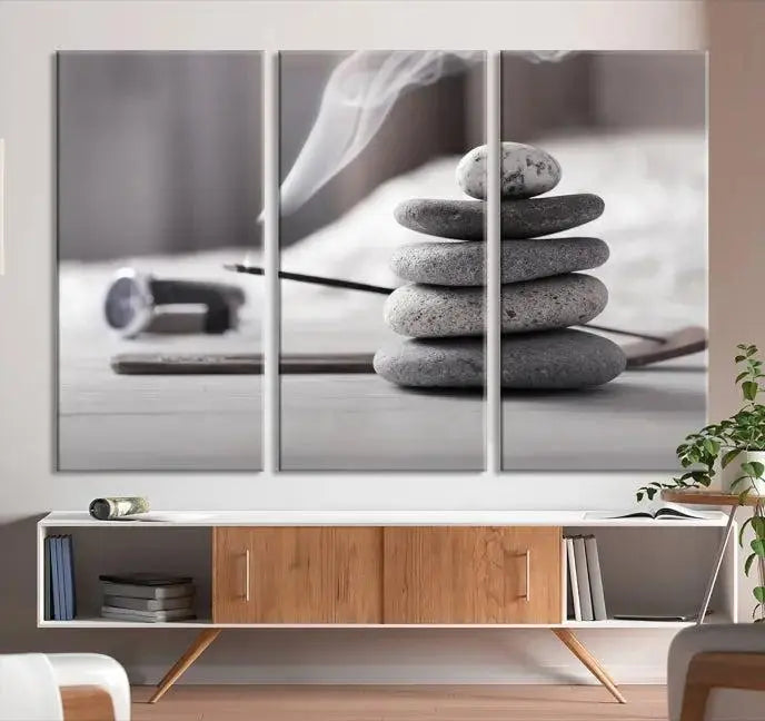 The "Burning Incense and Zen Stones Buddhism Wall Art Canvas Print" adds an artistic touch to the contemporary living room with its museum-quality depiction of stacked stones and incense smoke.