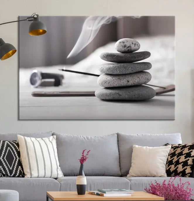 The "Burning Incense and Zen Stones Buddhism Wall Art Canvas Print" adds an artistic touch to the contemporary living room with its museum-quality depiction of stacked stones and incense smoke.