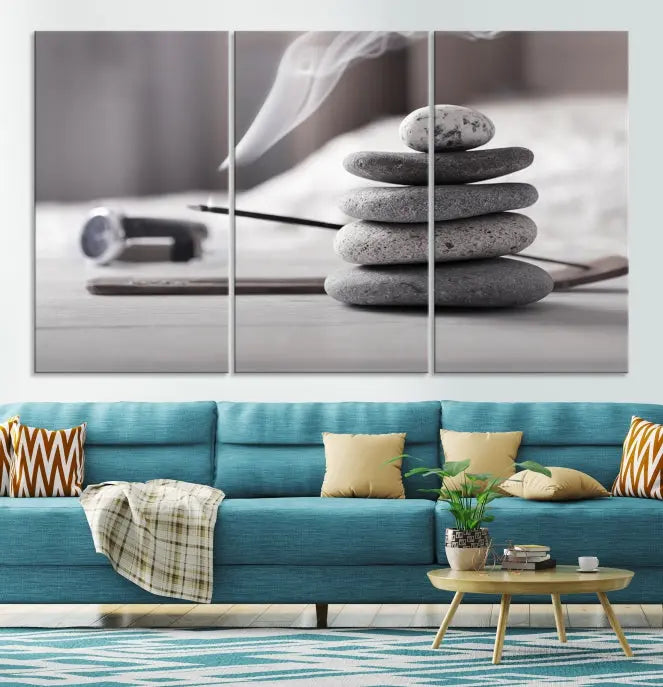 The "Burning Incense and Zen Stones Buddhism Wall Art Canvas Print" adds an artistic touch to the contemporary living room with its museum-quality depiction of stacked stones and incense smoke.