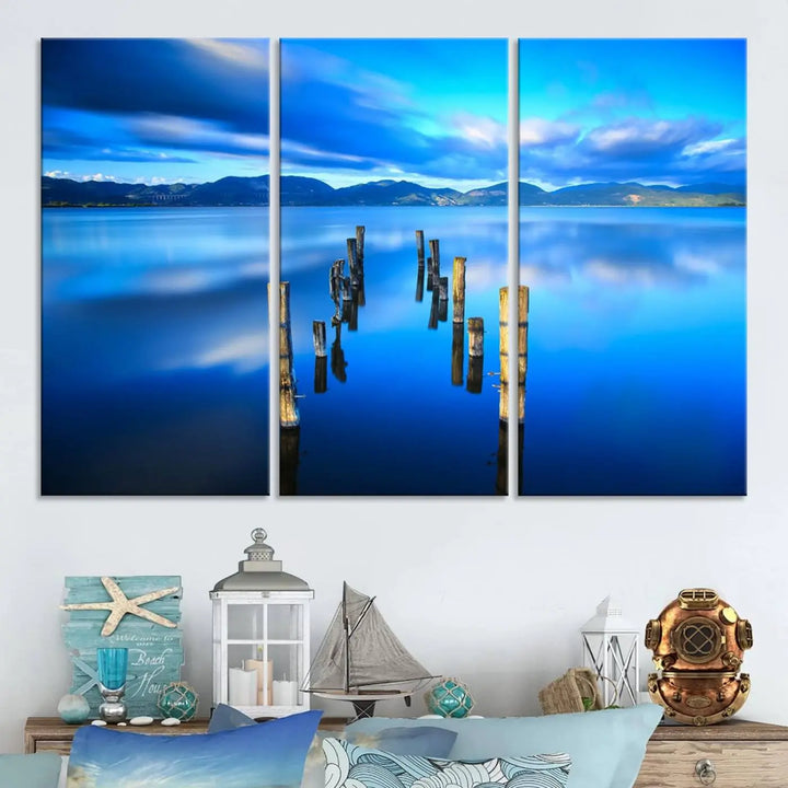 The Calm Waters Lake Canvas Art, featuring a tranquil pier reflection set against a mountainous backdrop, showcases its elegance with a gallery wrap and Canon print quality.