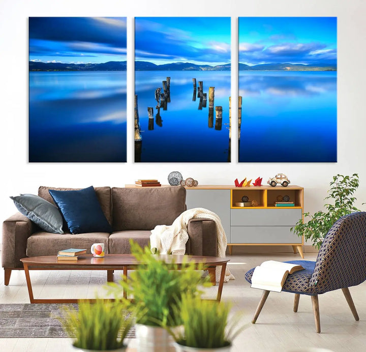 The Calm Waters Lake Canvas Art, featuring a tranquil pier reflection set against a mountainous backdrop, showcases its elegance with a gallery wrap and Canon print quality.