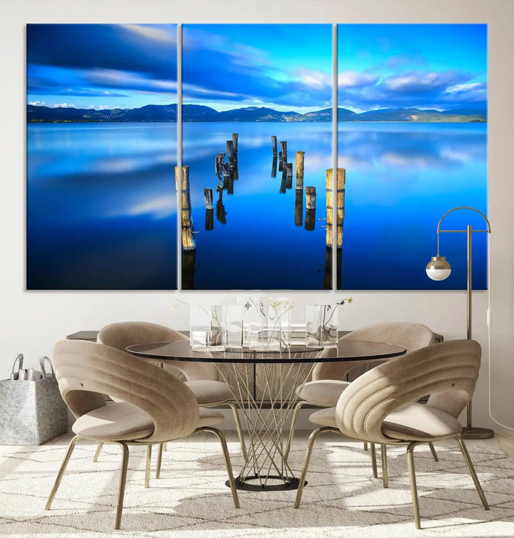 The Calm Waters Lake Canvas Art, featuring a tranquil pier reflection set against a mountainous backdrop, showcases its elegance with a gallery wrap and Canon print quality.