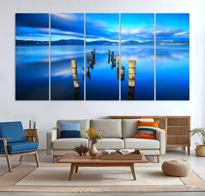 The Calm Waters Lake Canvas Art, featuring a tranquil pier reflection set against a mountainous backdrop, showcases its elegance with a gallery wrap and Canon print quality.