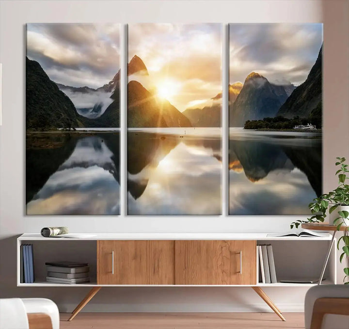 A captivating natural landscape wall art canvas print features a serene lake and majestic mountains illuminated by a dramatic sunset. This gallery-wrapped image is printed on museum-quality polycotton canvas, ensuring its timeless charm for years to come.